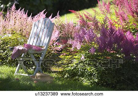 White table and chairs in grassy corner of rough mown lawn. View Large Photo Image Stock Photo - White table and chairs in grassy corner of rough mown lawn.. Fotosearch