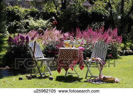 White table and chairs in grassy corner of rough mown lawn. View Large Photo Image Stock Photography - White table and chairs in grassy corner of rough mown lawn.. Fotosearch