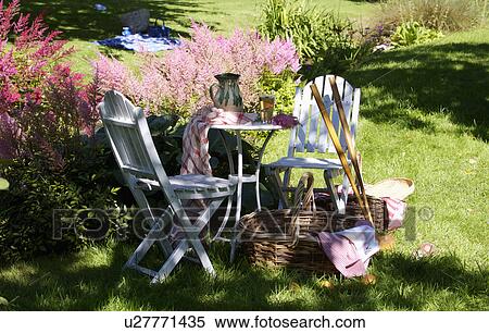 White table and chairs in grassy corner of rought mown lawn. View Large Photo Image Stock Photography - White table and chairs in grassy corner of rought mown lawn.. Fotosearch