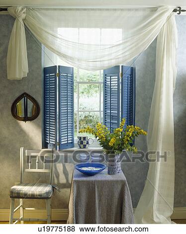 White voile drapes and blue plantation shutters on window View Large Photo Image Stock Photo - White voile drapes and blue plantation shutters on window. Fotosearch