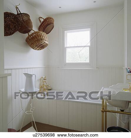 Pictures Of White Wood Panelled Bathroom With Baskets Hanging On The Picture White Wood Panelled Bathroom With Baskets Hanging On The Wall Fotosearch