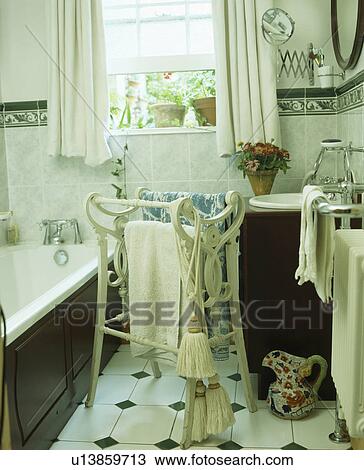 White wooden Victorian towel-rail in small traditional bathroom View Large Photo Image Stock Image - White wooden Victorian towel-rail in small traditional bathroom. Fotosearch