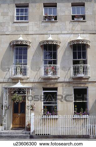 White wrought iron balconies and canopies on Regency terraced townhouse with white railings View Large Photo Image Stock Image - White wrought iron balconies and canopies on Regency terraced townhouse with white railings. Fotosearch