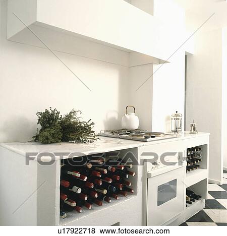 Wine bottles stored on open shelves in compact modern all-white kitchen View Large Photo Image Stock Photo - Wine bottles stored on open shelves in compact modern all-white kitchen. Fotosearch