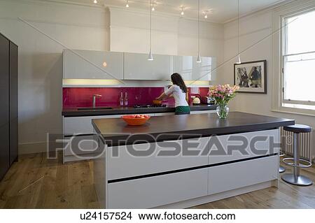 Picture - Woman cooking in modern kitchen. Fotosearch