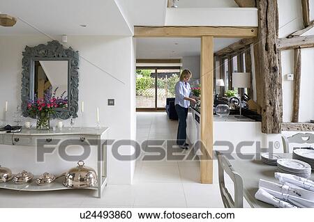 Woman in modern barn conversion kitchen View Large Photo Image Stock Image - Woman in modern barn conversion kitchen. Fotosearch