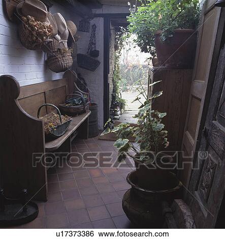 Wooden bench in country hall with terracotta floor tiles View Large Photo Image Stock Photograph - Wooden bench in country hall with terracotta floor tiles. Fotosearch