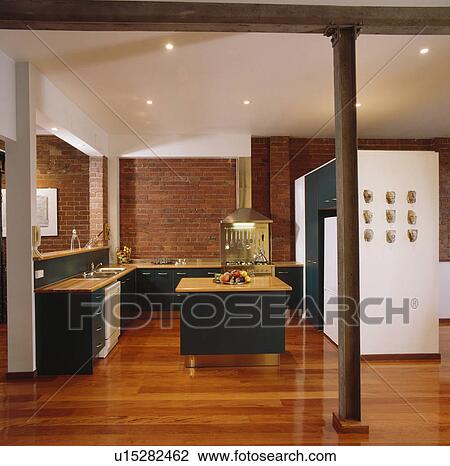 Wooden flooring and black fitted units in modern kitchen View Large Photo Image Stock Image - Wooden flooring and black fitted units in modern kitchen. Fotosearch