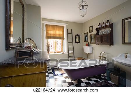 Wooden ladder beside window with roman blind in bathroom with roll-top blind and black+white chequerboard floor View Large Photo Image Picture - Wooden ladder beside window with roman blind in bathroom with roll-top blind and black+white chequerboard floor. Fotosearch