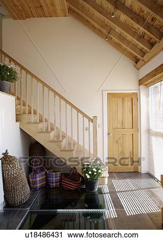 Wooden staircase and beamed ceiling in contemporary coastal hall with flagstoned floor View Large Photo Image Stock Image - Wooden staircase and beamed ceiling in contemporary coastal hall with flagstoned floor. Fotosearch