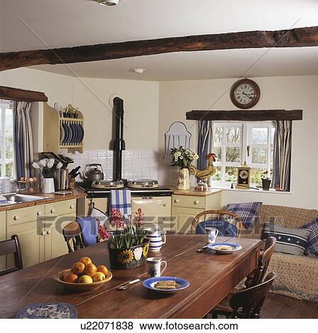 Wooden table in white cottage kitchen View Large Photo Image Stock Photo - Wooden table in white cottage kitchen. Fotosearch