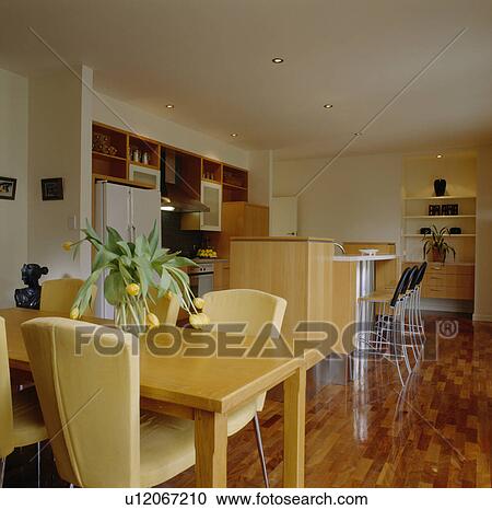 Yellow chairs and wooden table in modern kitchen View Large Photo Image Stock Image - Yellow chairs and wooden table in modern kitchen. Fotosearch