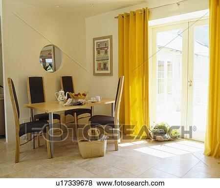 Yellow curtains and limestone flooring in modern dining room View Large Photo Image Stock Photo - Yellow curtains and limestone flooring in modern dining room. Fotosearch