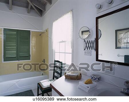 Yellow tiled wall above bath in modern white bathroom View Large Photo Image Stock Photo - Yellow tiled wall above bath in modern white bathroom. Fotosearch