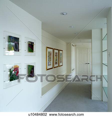 Stock Image - Abstract pictures on walls on modern hall corridor. Fotosearch