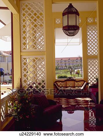 Stock Image - Airy lounge in Indian hotel with view of garden. Fotosearch
