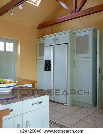 American-style fridge-freezer in terracotta country kitchen with pale turquoise fitted units View Large Photo Image Stock Photograph - American-style fridge-freezer in terracotta country kitchen with pale turquoise fitted units. Fotosearch