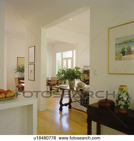 Stock Photo - Antique console table in modern openplan white hall. Fotosearch