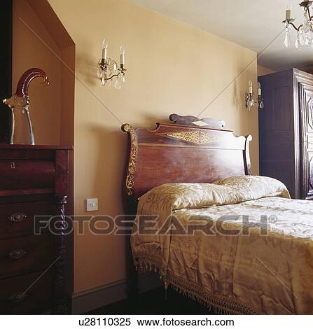 Antique Mahogany Headboard On Bed With Cream Silk Bedcover In Antique Mahogany Headboard On Bed With