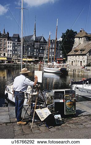 Stock Image - Artist painting at Honfleur Harbour in Normandy, France. Fotosearch