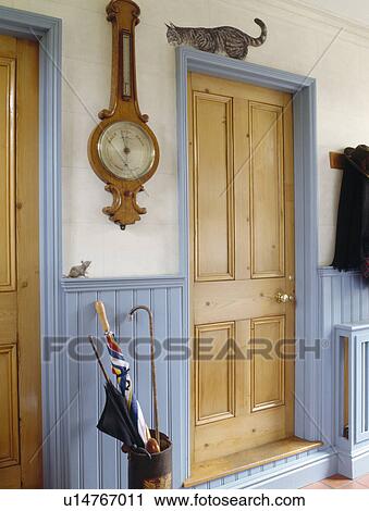 Barometer on wall above pastel blue dado panelling in small hall with pine door View Large Photo Image Stock Image - Barometer on wall above pastel blue dado panelling in small hall with pine door. Fotosearch