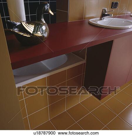 Basin in red vanity unit in yellow tiled bathroom View Large Photo Image Stock Image - Basin in red vanity unit in yellow tiled bathroom. Fotosearch
