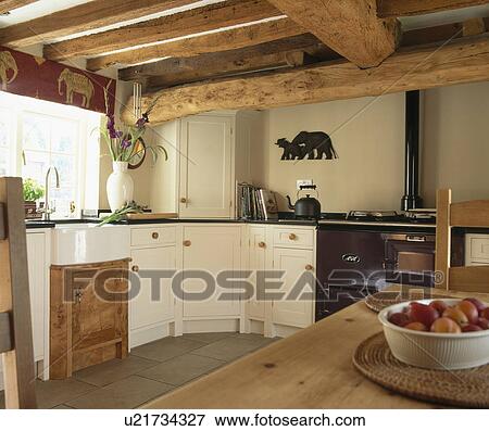 Beamed Ceiling In Traditional Country Cottage Kitchen Stock Photo