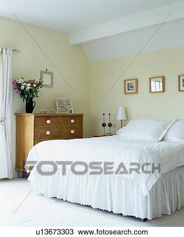 Bed with white bedlinen in cream country bedroom View Large Photo Image Stock Image - Bed with white bedlinen in cream country bedroom. Fotosearch