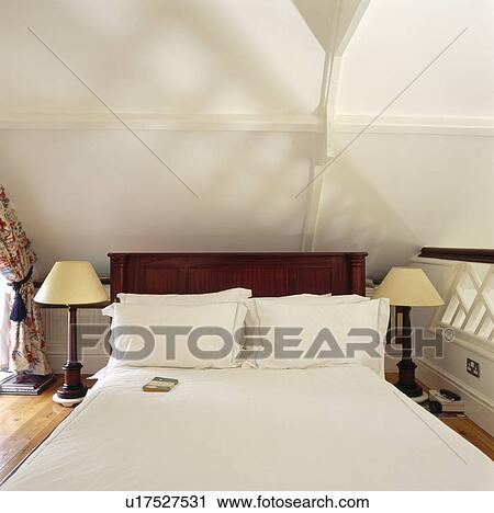 Bed with white bedlinen in modern white bedroom View Large Photo Image Stock Image - Bed with white bedlinen in modern white bedroom. Fotosearch