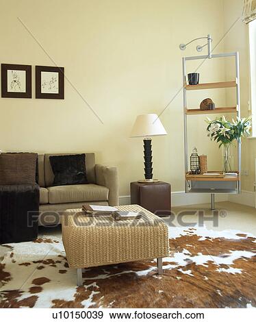 Stock Photo - Beige sofa in modern white living room with faux ponyskin rug. Fotosearch