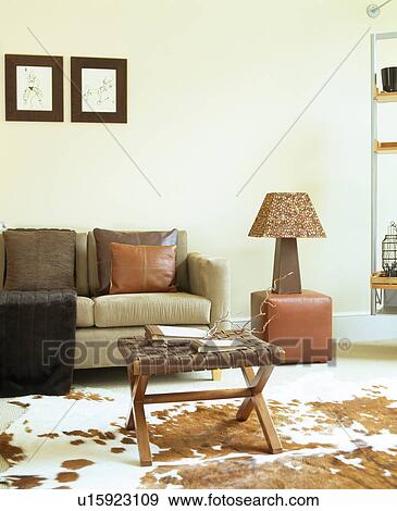 Beige sofa in modern white living room with faux ponyskin rug View Large Photo Image Stock Photo - Beige sofa in modern white living room with faux ponyskin rug. Fotosearch