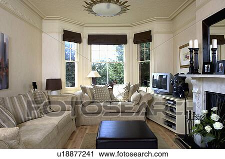 Beige sofas in cream living room with black blinds on bay window View Large Photo Image Stock Image - Beige sofas in cream living room with black blinds on bay window. Fotosearch