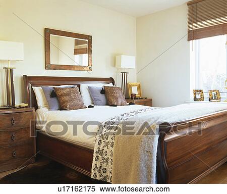 Stock Photography - Beige wool throw on lit bateau in modern cream bedroom. Fotosearch