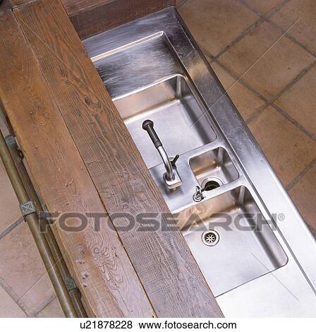 Stock Photo - Birdseye close-up of double stainless steel sinks. Fotosearch