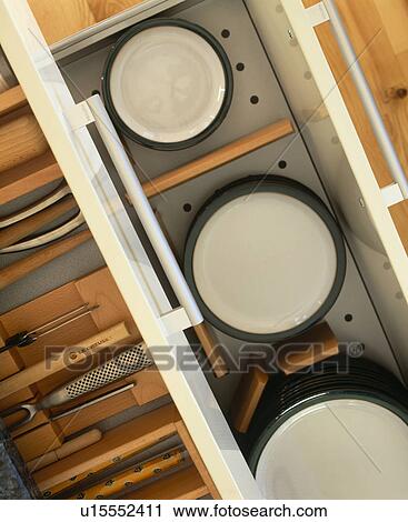 Stock Image - Birdseye close-up view of cutlery storage and plate warming drawer. Fotosearch