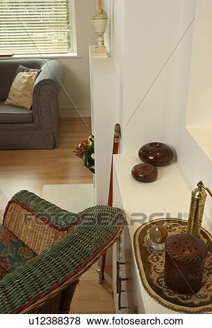 Stock Photo - Birdseye view of cream living room with wicker armchair. Fotosearch