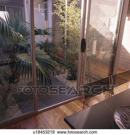 Birdseye view of dining room with glass door open to atrium View Large Photo Image Stock Photo - Birdseye view of dining room with glass door open to atrium. Fotosearch