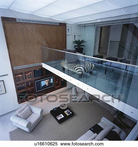 Stock Photography - Birdseye view of large openplan mezzanine floor and living room . Fotosearch