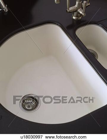 Birdseye view of white underset double sinks in black granite worktop View Large Photo Image Stock Photo - Birdseye view of white underset double sinks in black granite worktop. Fotosearch
