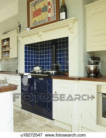 Stock Photo - Black Aga oven in traditional cream country kitchen. Fotosearch