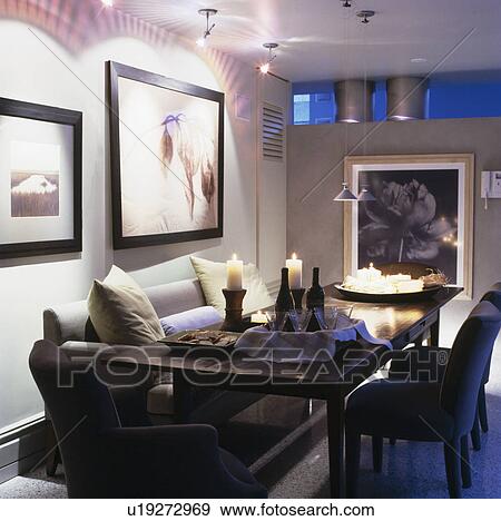 Black armchairs and grey sofa at dark wood table in city apartment dining room View Large Photo Image Stock Photo - Black armchairs and grey sofa at dark wood table in city apartment dining room. Fotosearch