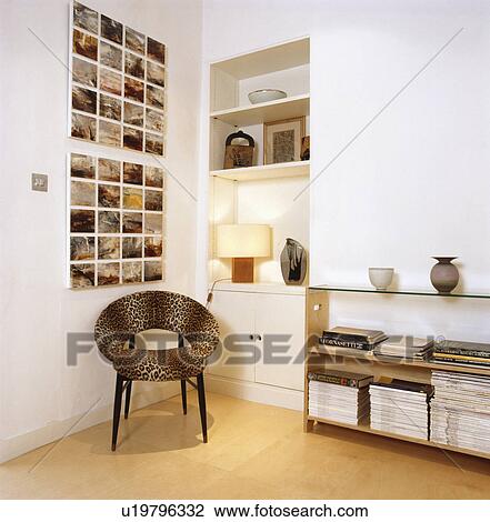 Stock Image - Black chair in modern white living room. Fotosearch