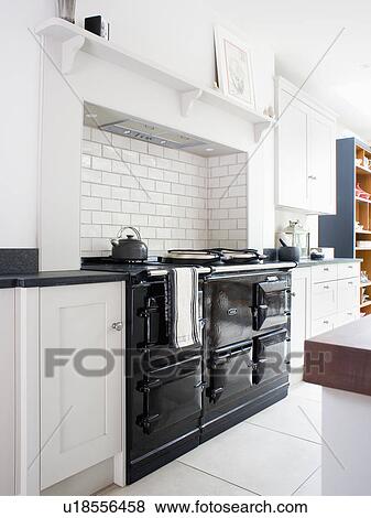 Stock Photo - Black double Aga oven in modern white kitchen. Fotosearch