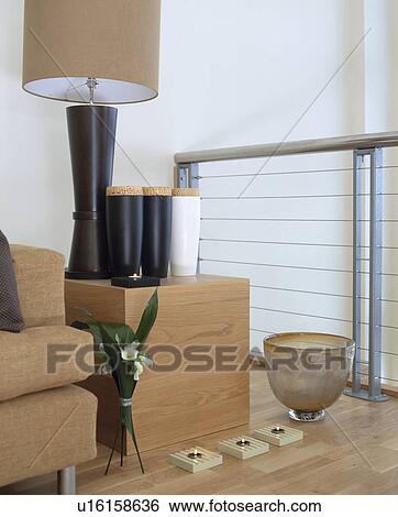 Black lamp on modern square wooden table in modern living room View Large Photo Image Stock Photograph - Black lamp on modern square wooden table in modern living room. Fotosearch