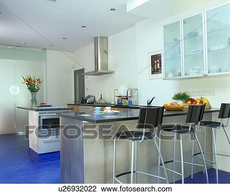 Black leather and chrome stools at breakfast bar in modern kitchen with bright blue Marmoleum flooring View Large Photo Image Stock Image - Black leather and chrome stools at breakfast bar in modern kitchen with bright blue Marmoleum flooring. Fotosearch