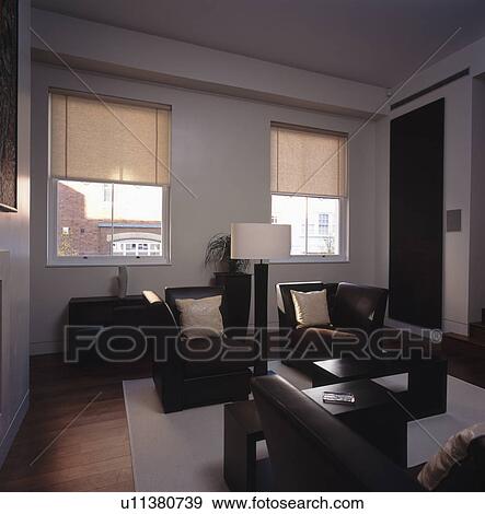 Black leather armchairs in modern white living room with cream blinds View Large Photo Image Stock Photo - Black leather armchairs in modern white living room with cream blinds. Fotosearch