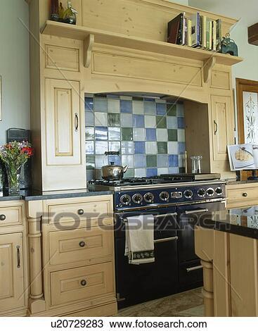 Stock Image - Black range oven in traditional country kitchen. Fotosearch