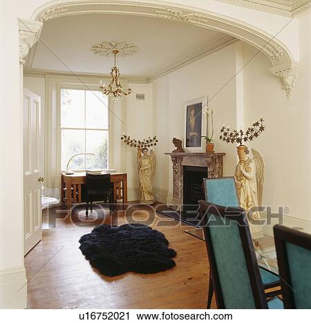 Black Sheepskin Rug On Wooden Floor In Dining Room With Stone