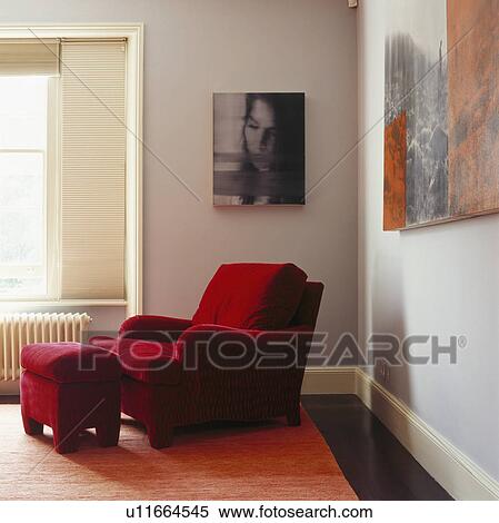 Black & white picture above red velour armchair and matching stool in modern living room View Large Photo Image Stock Photography - Black & white picture above red velour armchair and matching stool in modern living room. Fotosearch
