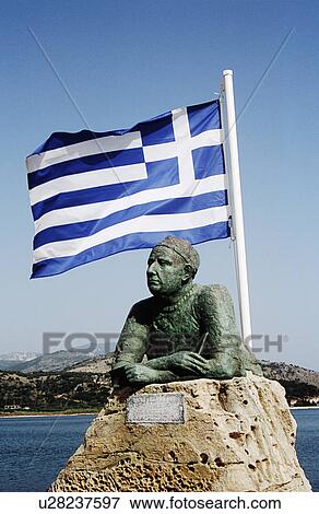 Blue and white national Greek flag flying above statue on stone plinth by the sea in Argostoli on Kefalonia in Greece View Large Photo Image Stock Photo - Blue and white national Greek flag flying above statue on stone plinth by the sea in Argostoli on Kefalonia in Greece. Fotosearch